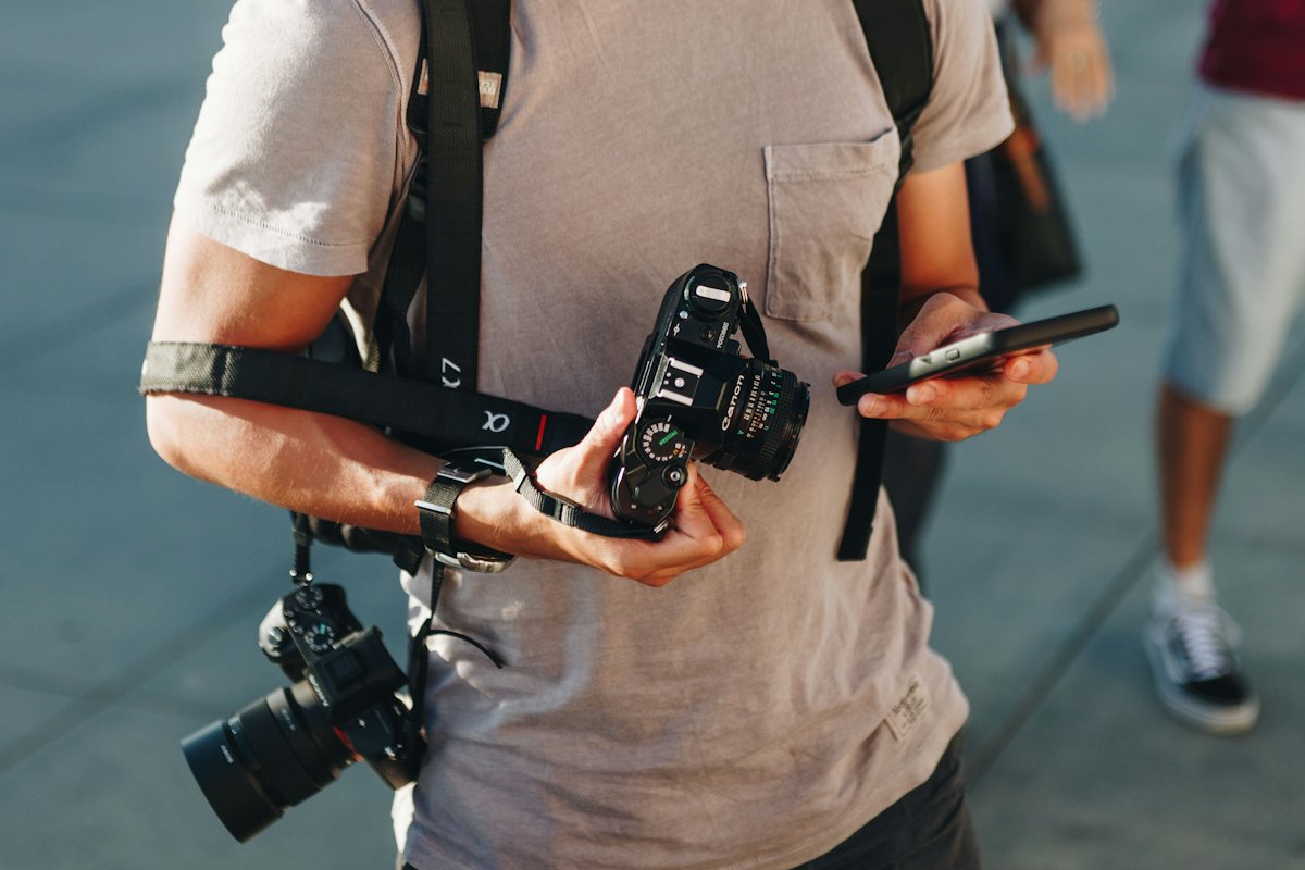 A renter checking a camera and phone before handover